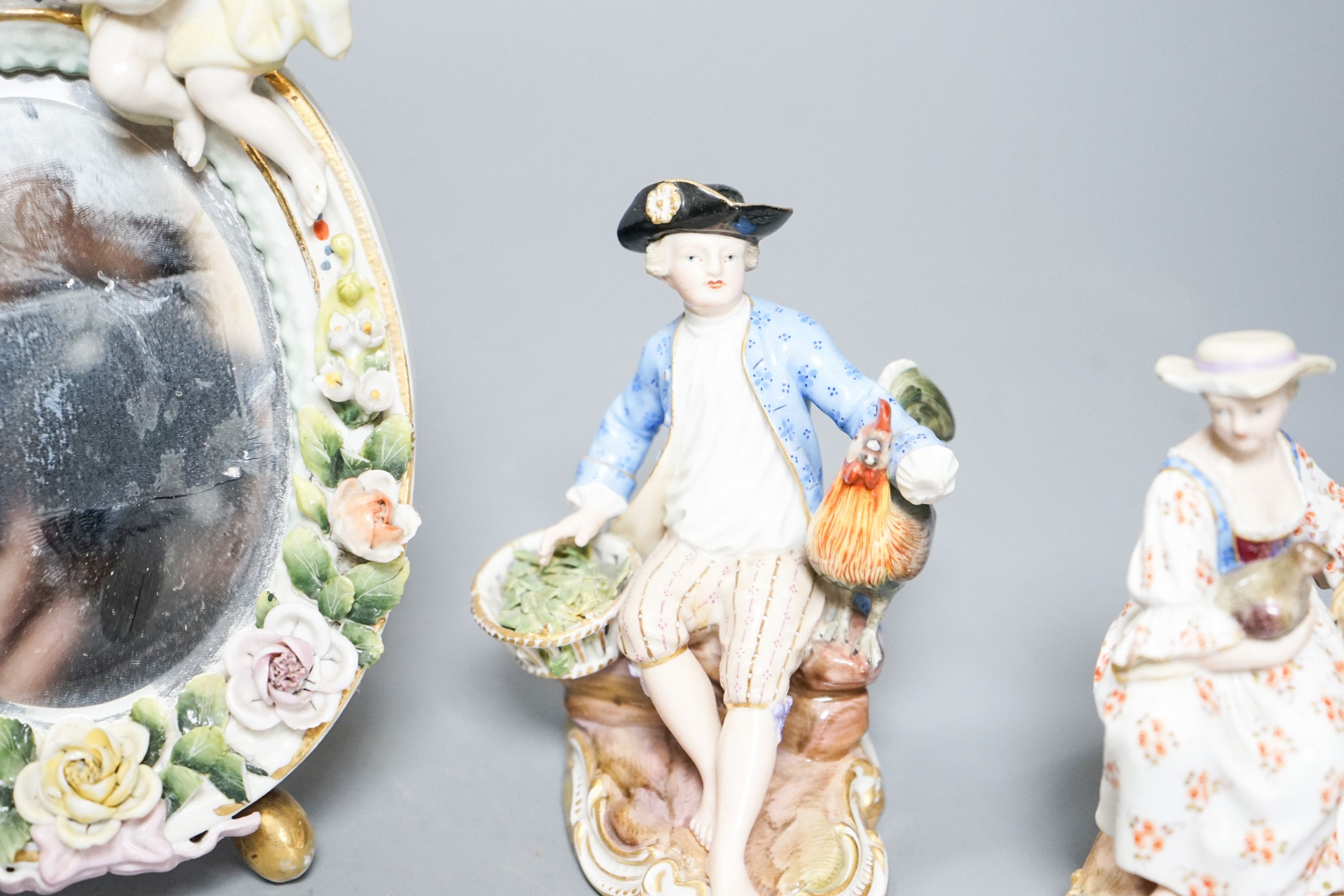 A pair of Meissen groups holding chickens, 10.5cm, a pair of Sitzendorph figures and a Sitzendorf mirror 18cm